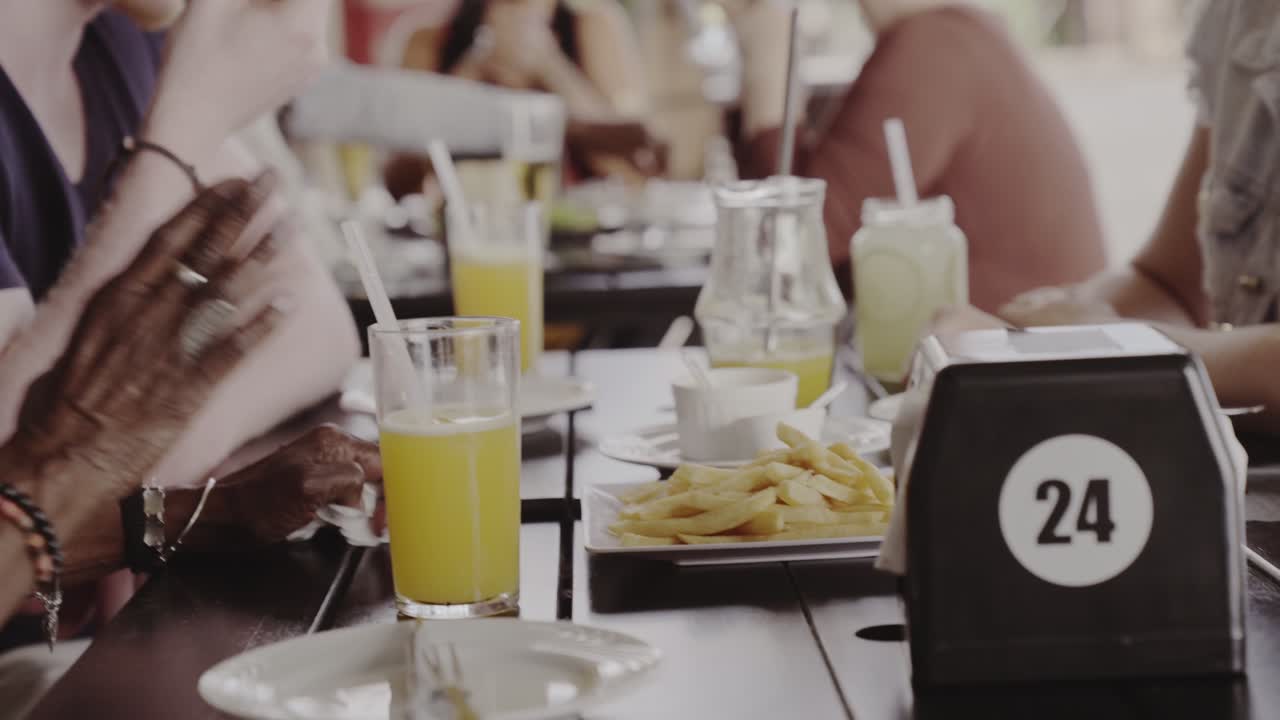 Diverse Group of Friends Dining and Socializing at a Cafe