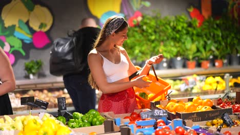 woman shopping for fruits and vegetables in a grocery store