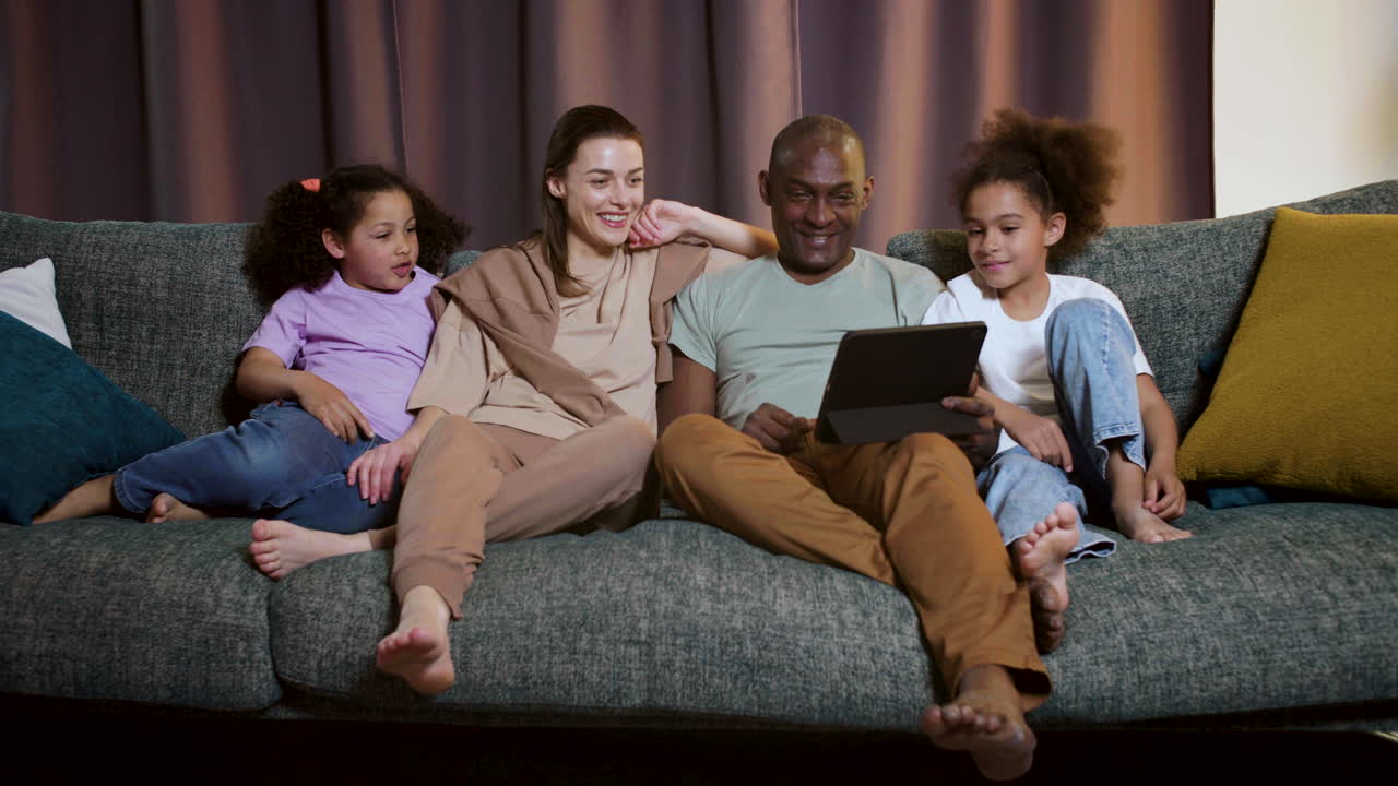 Family watching film at home