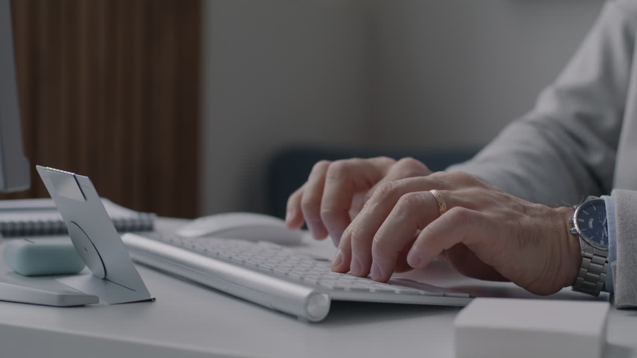 Person typing on a computer keyboard at a desk