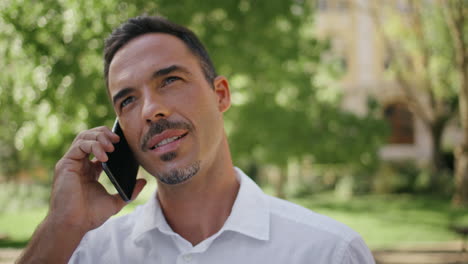 manager talking cellphone at sunbeams park closeup. boss answering call