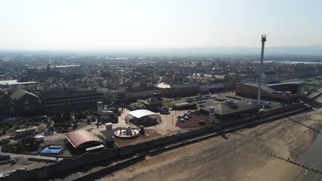 Popular-seaside-Rhyl-resort-town-aerial-view-above-coastal-fairground-beach-tourist-attraction