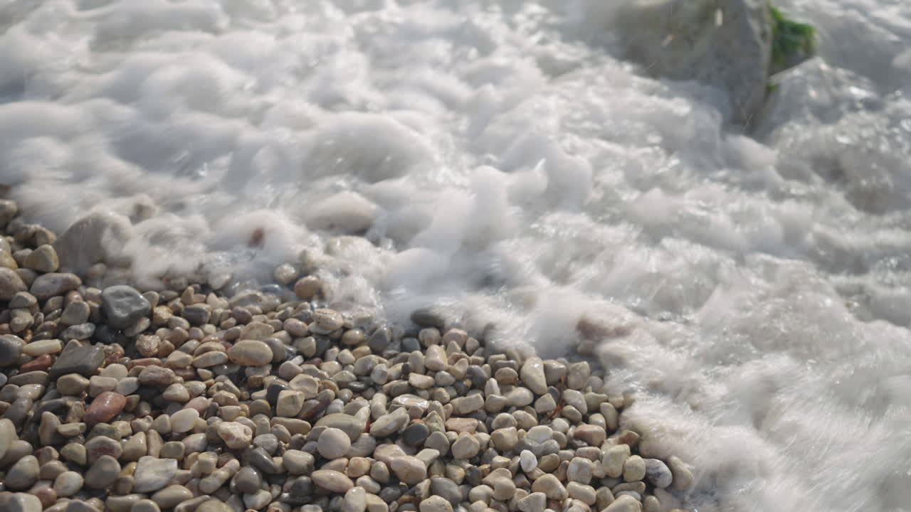 Seawater Crashing Over Stones on Rugged Coastline, Natural Force Concept