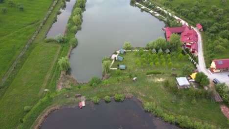 Reveal-type-shot-in-Colibita-Lake-in-Romania-with-views-to-the-valley-and-houses-in-the-valley