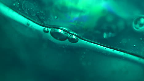 green bubbles in abstract macro background slow motion