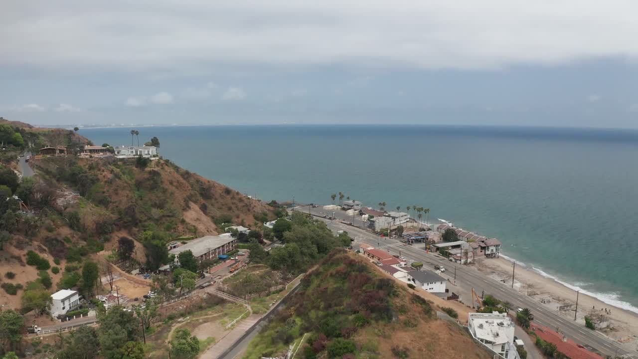 Wide rising aerial shot of Las Flores Canyon in Malibu, California after the Palisades Fire. 4K