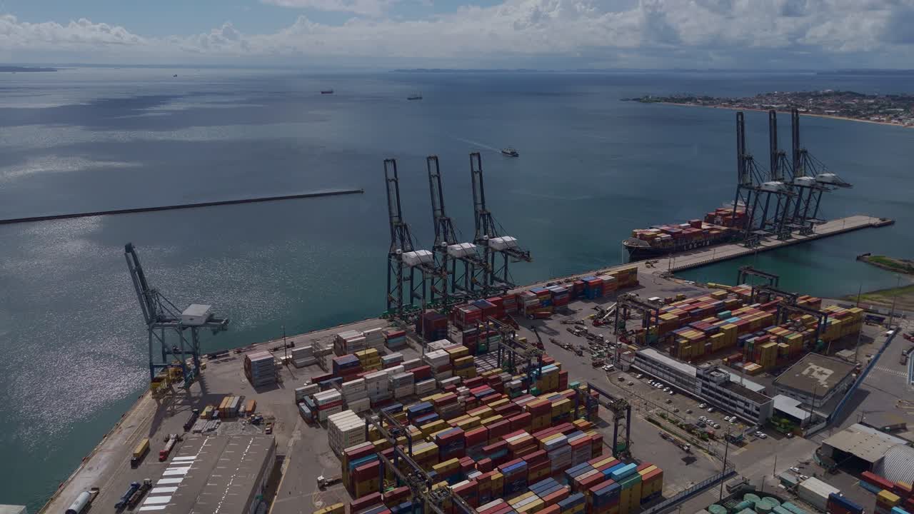 Strategic view of cargo infrastructure at the Port of Salvador with gantry cranes and shipping vessels, bahia