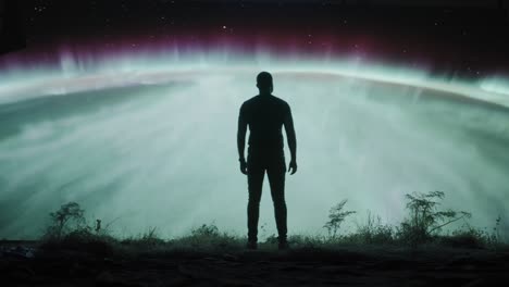 man gazing at the aurora borealis