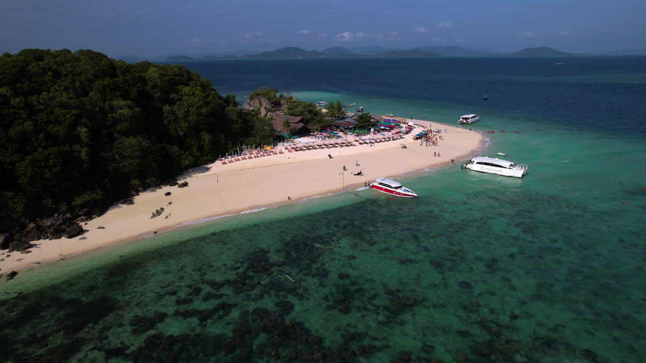 AERIAL: People walking from yacht over beach on Ko Khai Nok island, Thailand