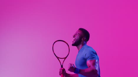 Video-of-successful-african-american-male-tennis-player-with-racket-in-neon-pink-lightning
