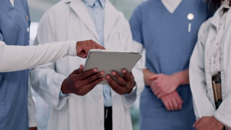 medical team collaborating with a tablet
