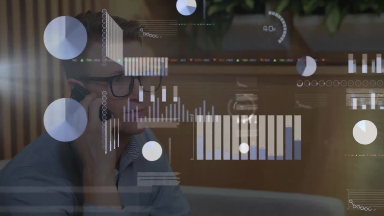 Animation of statistical data processing against caucasian man talking on smartphone at office