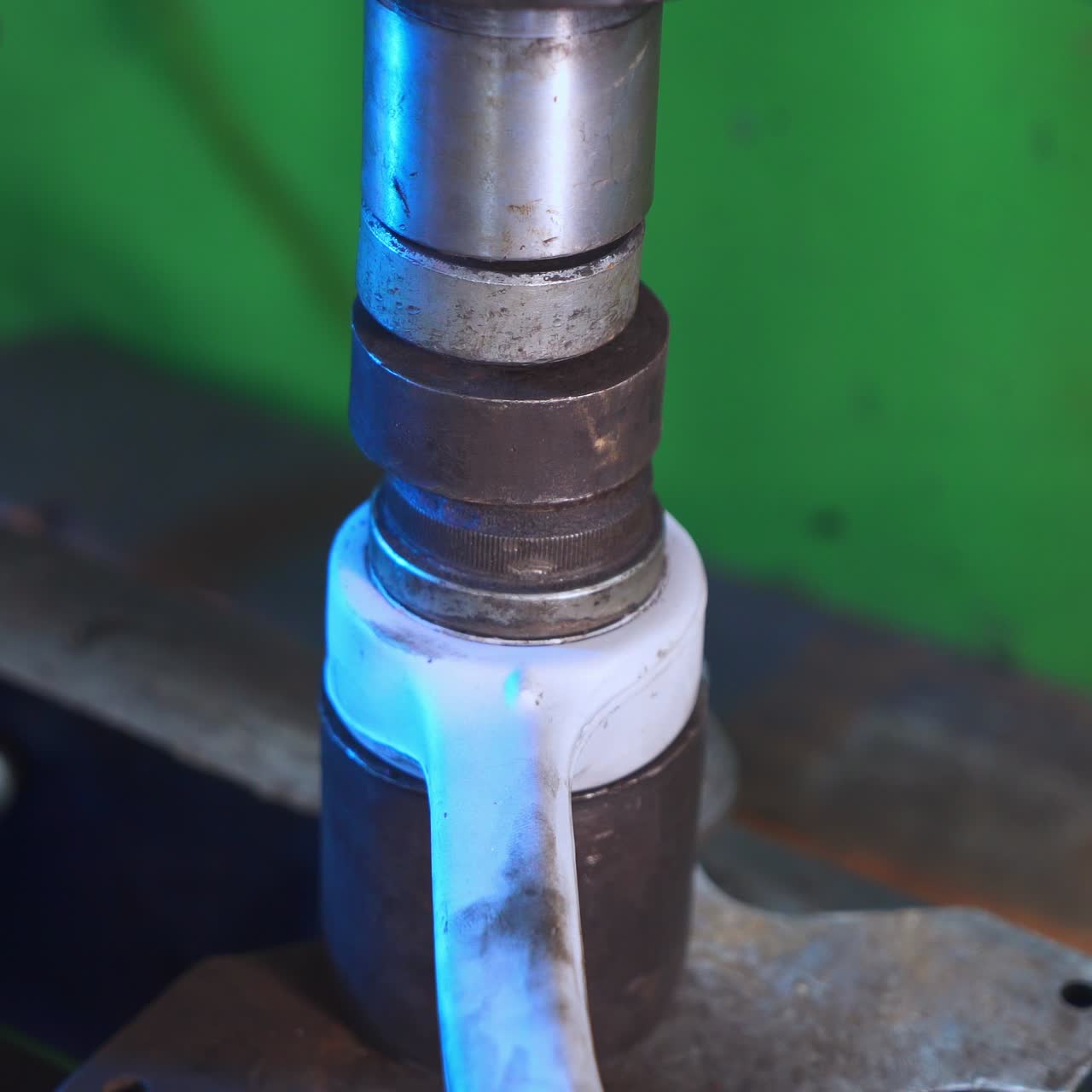 Turner's hand putting different details in a pile. Metal details stacked together. Equipment for turner close up. Blurred background