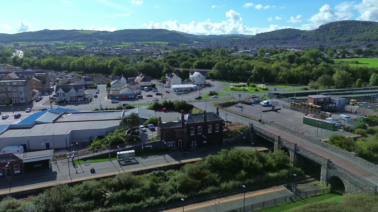 Penrhos and Abergele aerial view circling above the sunny coastal beachfront townscape suburb