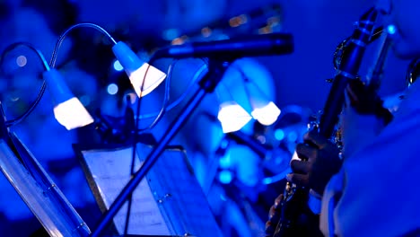 4k close-up of musician playing clarinet in night outdoor concert