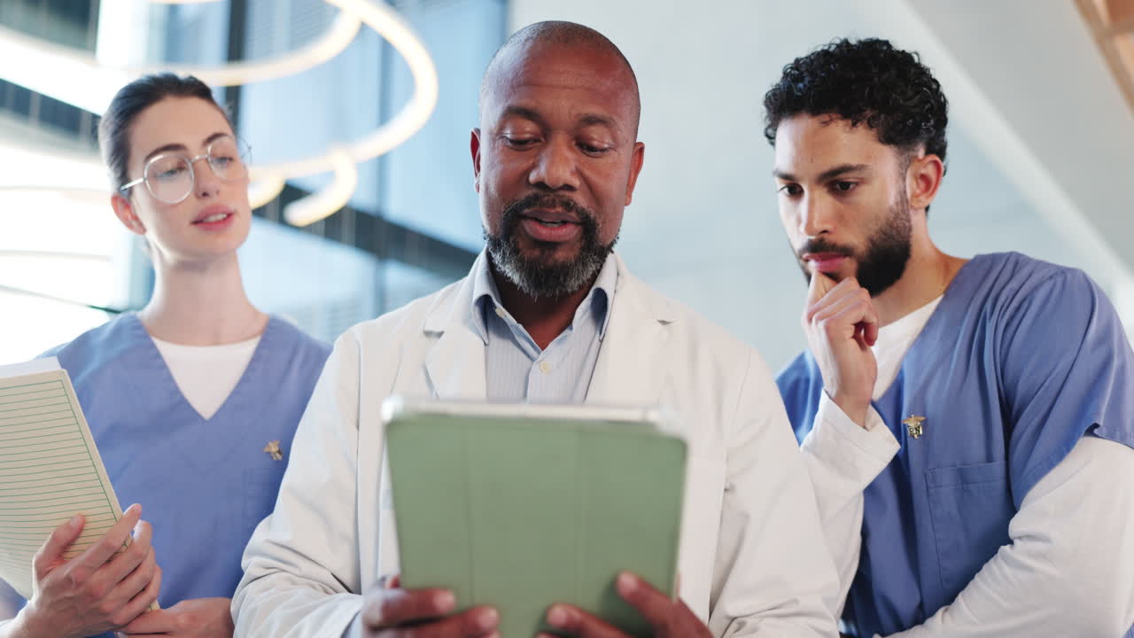 Doctor Discussing Medical Information on Tablet with Nurses