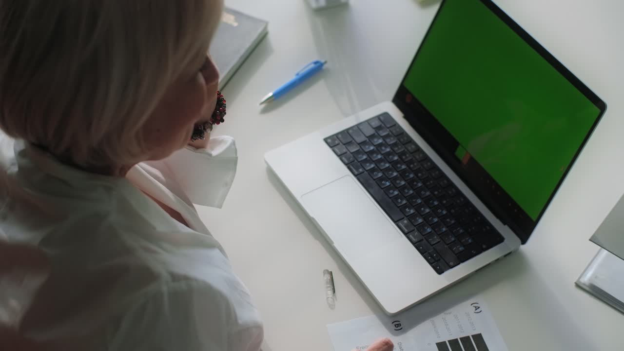 Senior Woman Working on Laptop and Documents