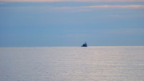 sea horizon with cargo ship silhouette - wide