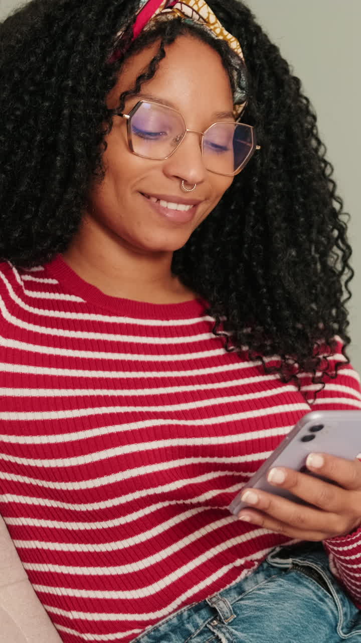 Smiling Young Woman Using Smartphone with Glasses and Headband