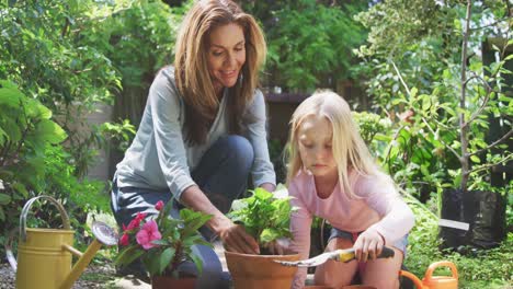 mother and daughter are replanting in the garden