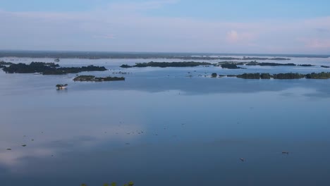 Aerial-Flying-Over-Calm-Reflective-Floodwaters-In-Sylhet,-Bangladesh