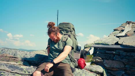 male hiker backpacker trail hiking in the mountain - medium shot