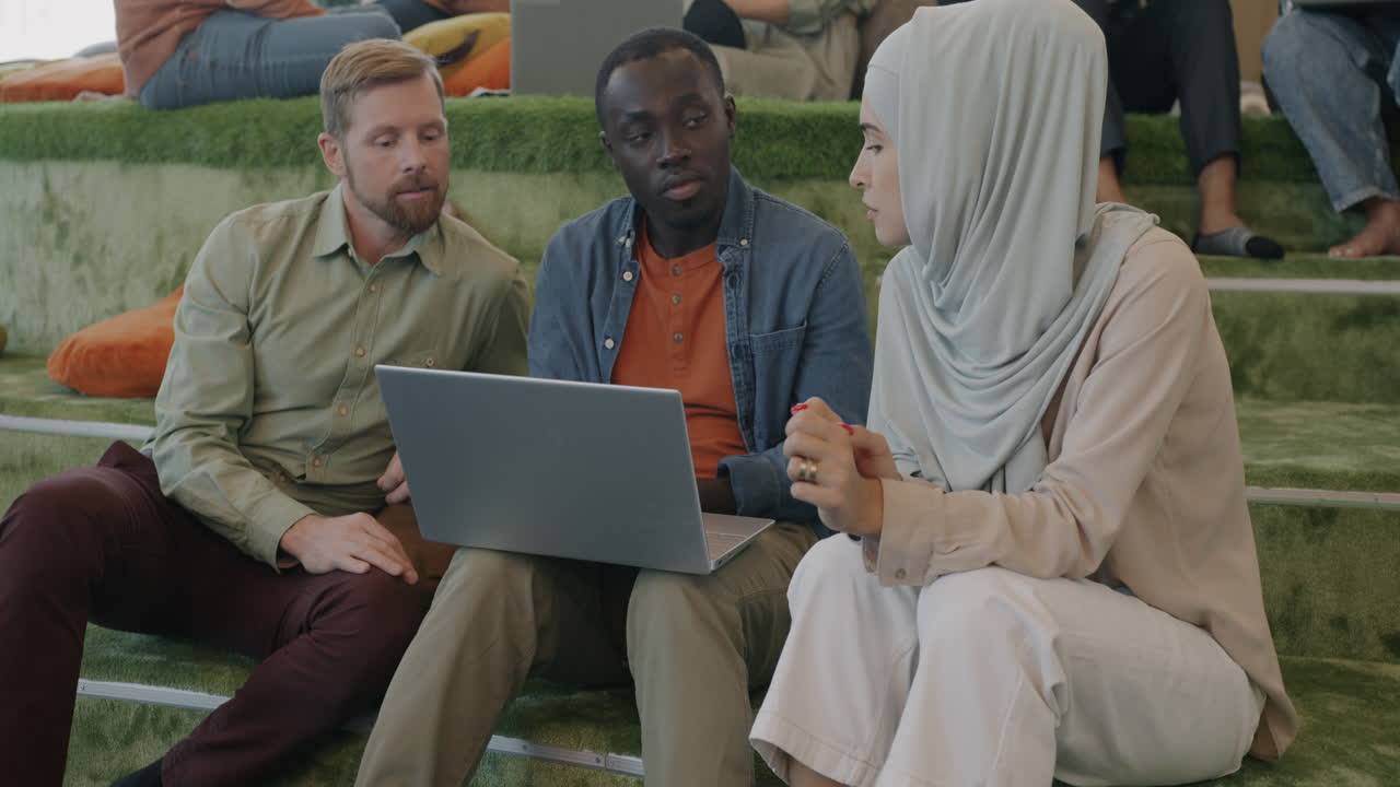 Diverse team collaborating on a laptop