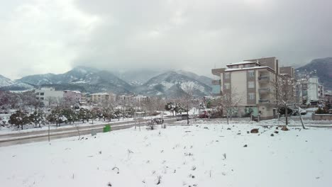 a slow, drone-like ascent captures a snowy day in denizli with cloud-covered skies