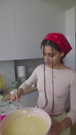 teenager baking in kitchen