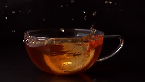 lemon slice falling in cup of tea