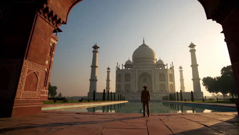 taj mahal at sunrise with man