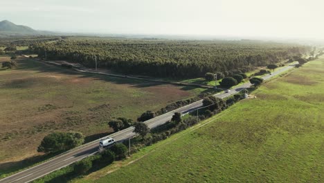 white van home driving on countryside road in portugal, aerial view