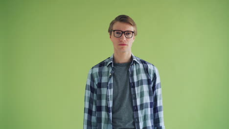 man with glasses in a plaid shirt, surprised expression