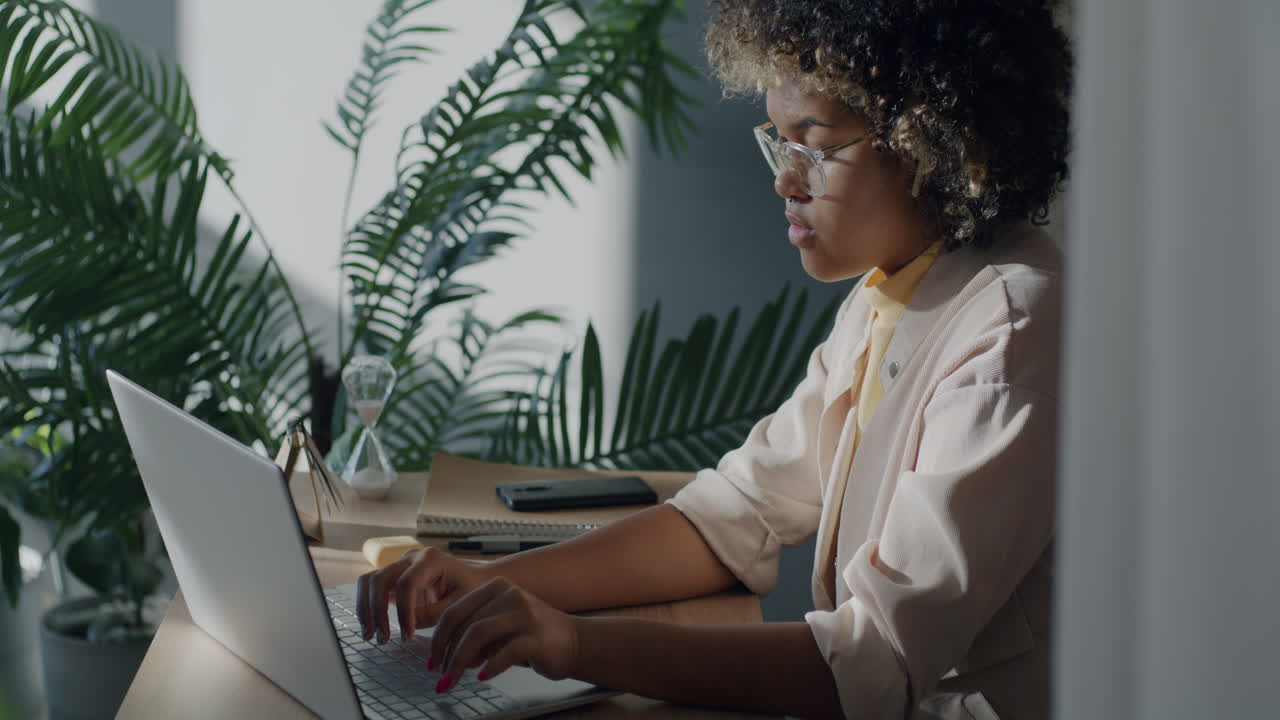 Woman Working on Laptop in a Home Office