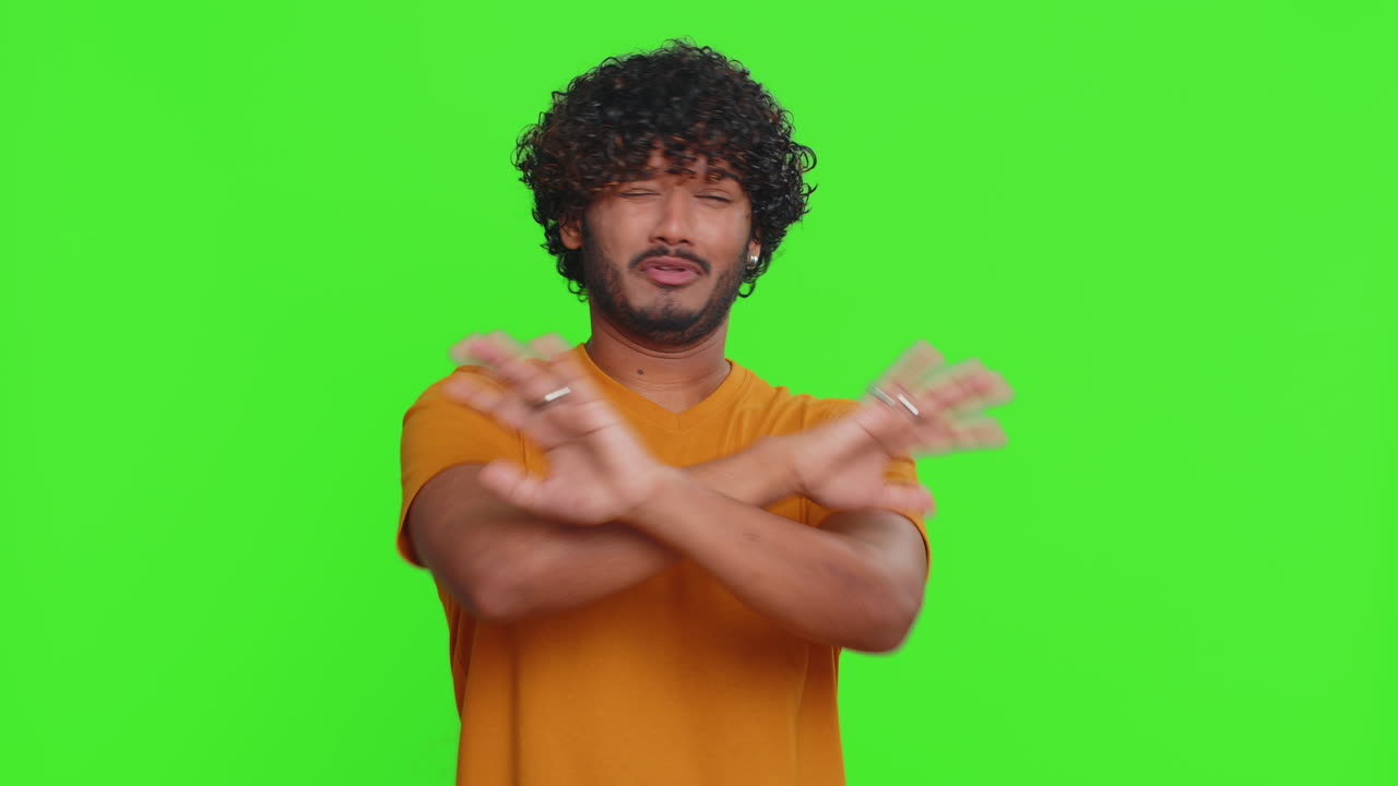 Afraid indian man closing eyes with hand showing stop gesture confused shy scared to watch awful