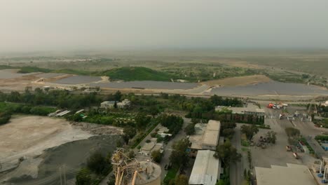 an aerial shot taken by a drone of a large cement factory.