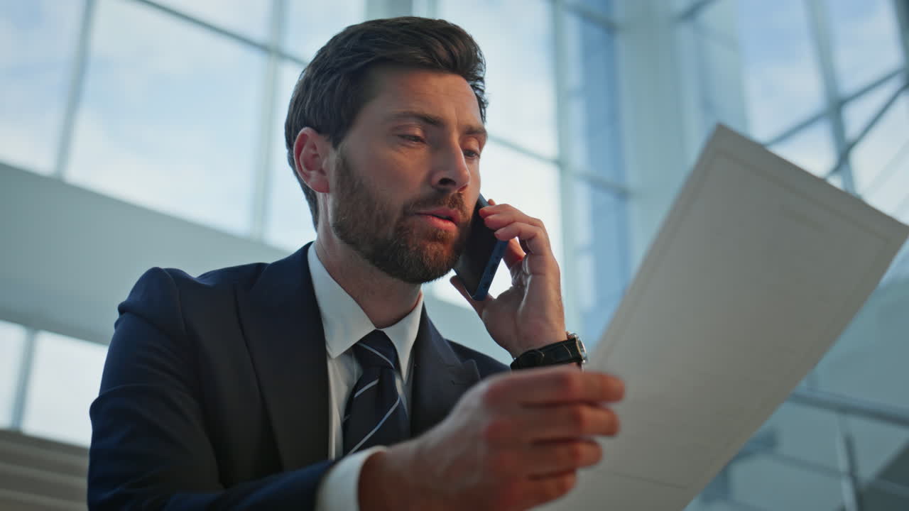 Calling businessman discussing document sitting office staircase closeup