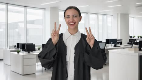 happy indian female lawyer showing victory sign