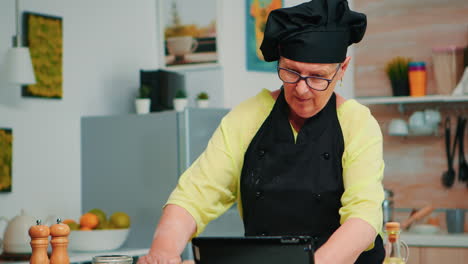 mujer chef usando tableta en la cocina