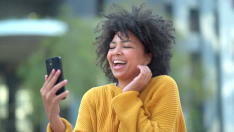 fun afro student taking selfies on phone
