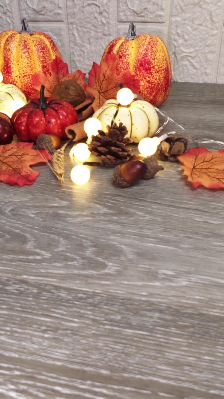 Autumnal Still Life Decoration with Pumpkins and Fairy Lights