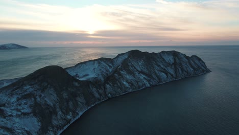 snowy mountain peninsula at sunset