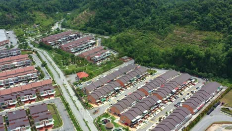 aerial views drone flyover goodview heights residential neighborhood capturing rows of double-storey terraced houses, hillside landscape and mountainous terrains, kajang, malaysia, southeast asia