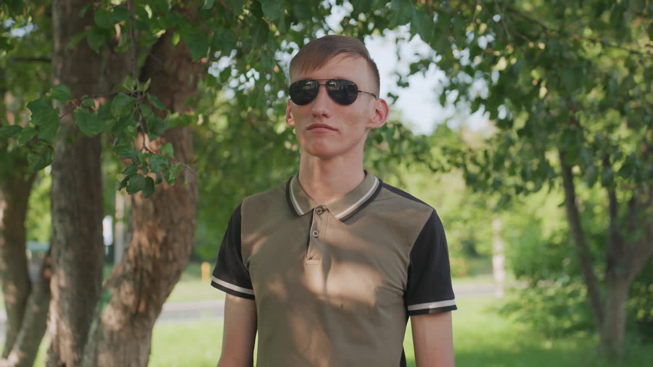 Proud Man Wearing Sunglasses Confidently, Caucasian Youth Displays Confidence Through Pose And Sunglasses, Young Man From Caucasus Region Exudes Selfconfidence With Firm Stance And Sunglasses