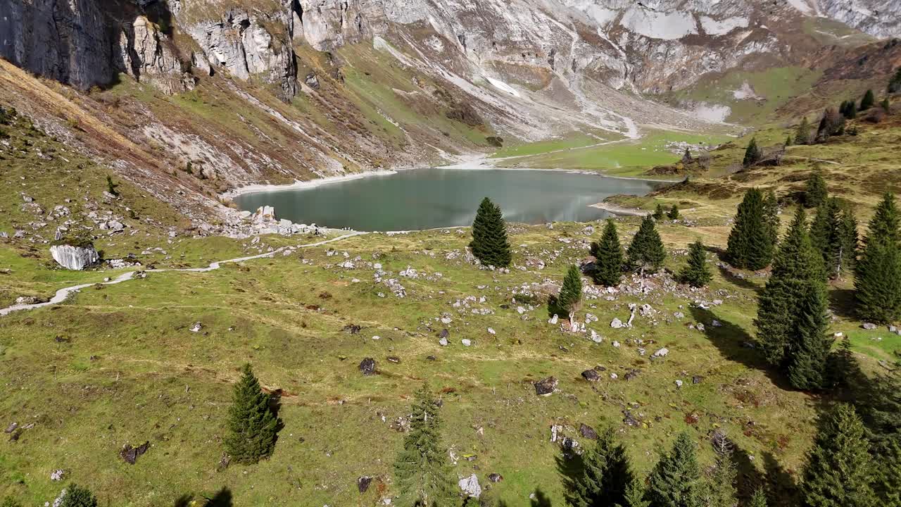 Mountain lake Oberblegisee in Luchsingen Switzerland with alpine views, trees, and rocky slopes