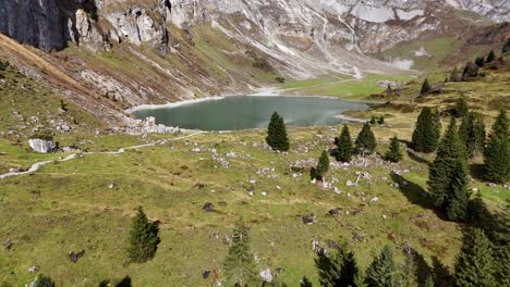 mountain lake oberblegisee in luchsingen switzerland with alpine views, trees, and rocky slopes