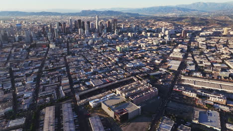 aerial view of a sprawling city skyline with mountains in the background