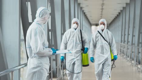 disinfection team in protective suits