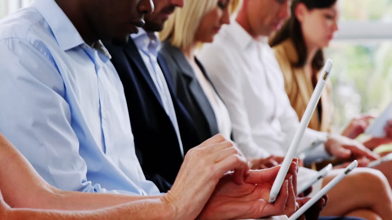 Business executives using mobile phone and digital tablet