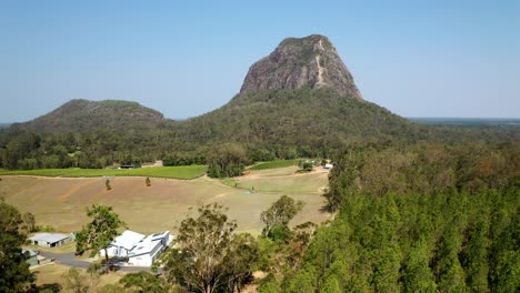 drive along mount beerwah road to glass house mountains national park in qld, australia - orbiting drone shot